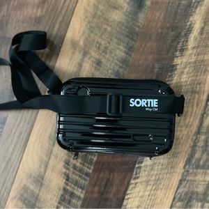 Hard shell crossbody accessory bag. Fully stocked with travel accessories